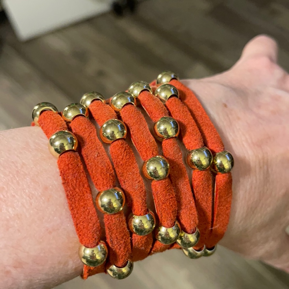 Beautiful orange suede cuffs with studs. NWOT. Never worn